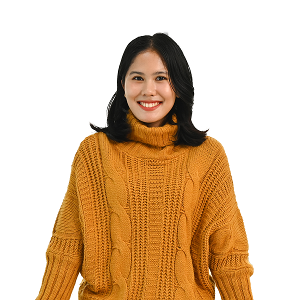 a women smiling with orange sweater